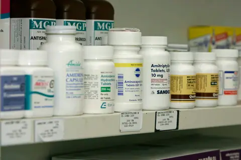 Shelves of medicine bottles in a pharmacy