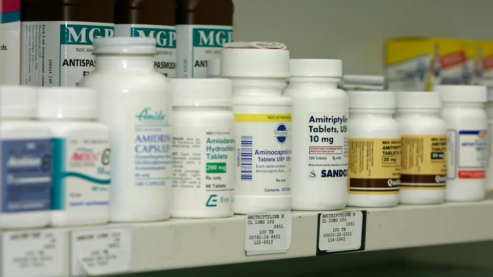 Shelves of medicine bottles in a pharmacy
